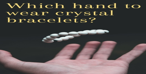Is a woman wearing a yellow crystal on her left or right hand
